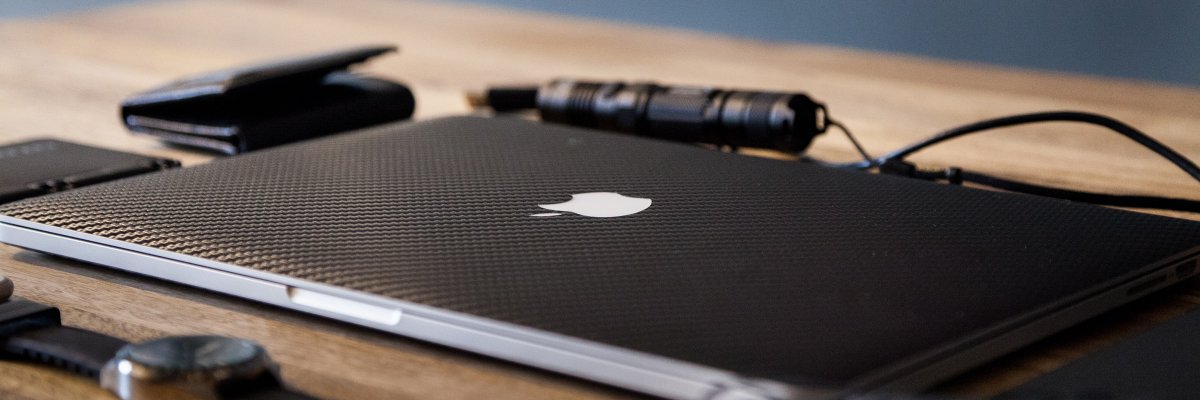 Macbook pro on brown wooden table